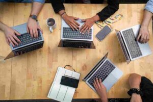 HOA board team collaborating on laptops during project planning